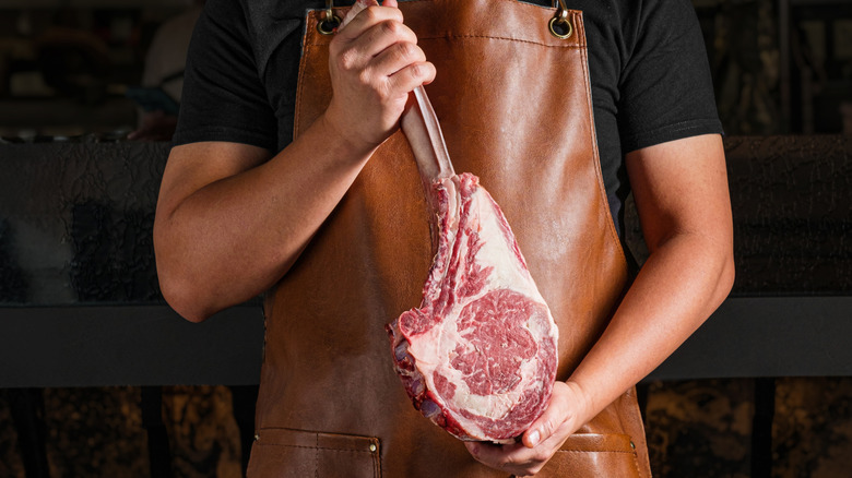 Butcher holding a steak