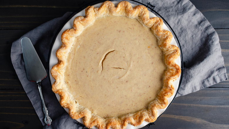 A pie with a browned crust on top of a towel
