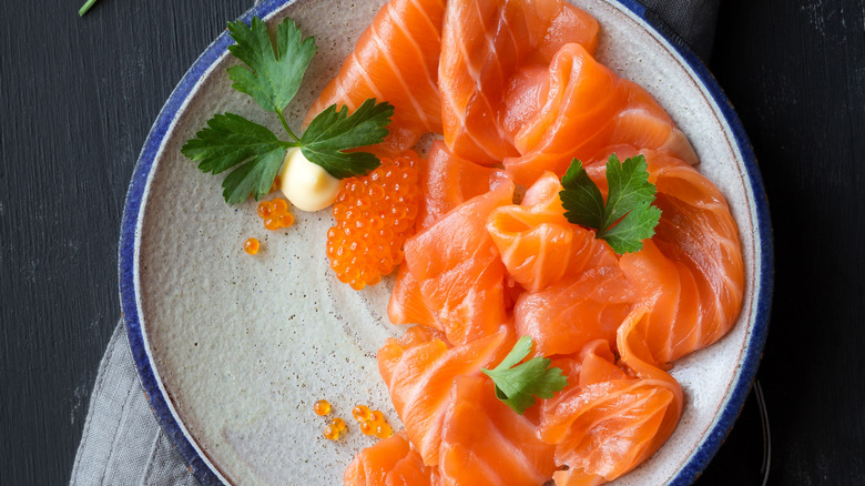 Smoked salmon arranged on a plate and photographed from above.