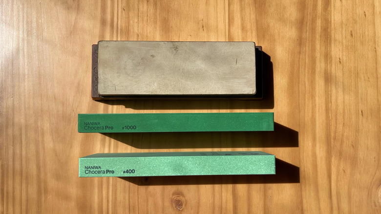 A 6000, 1000, and 400 grit stone lined up on a wooden table