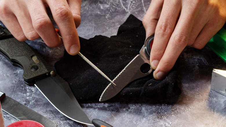 Sharpening a small serrated knife with a tapered honing rod
