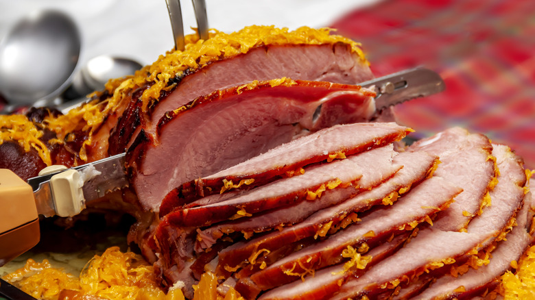 A smoked ham being sliced