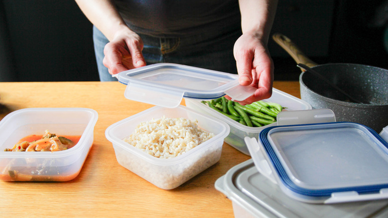 Leftover rice being put into a container