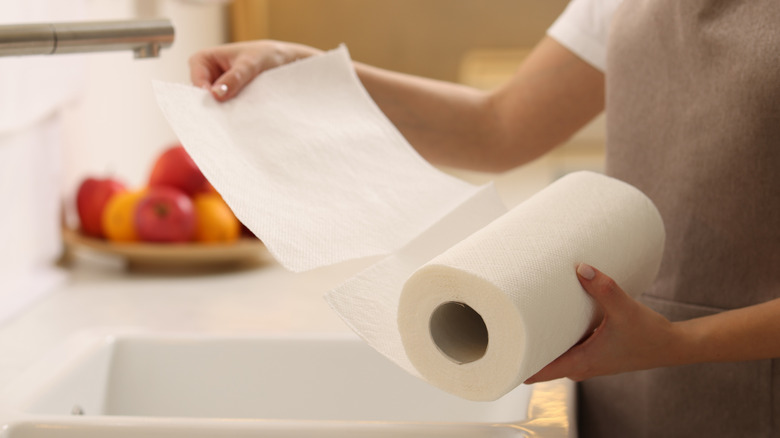 Photo of a woman unraveling a few sheets of paper towel