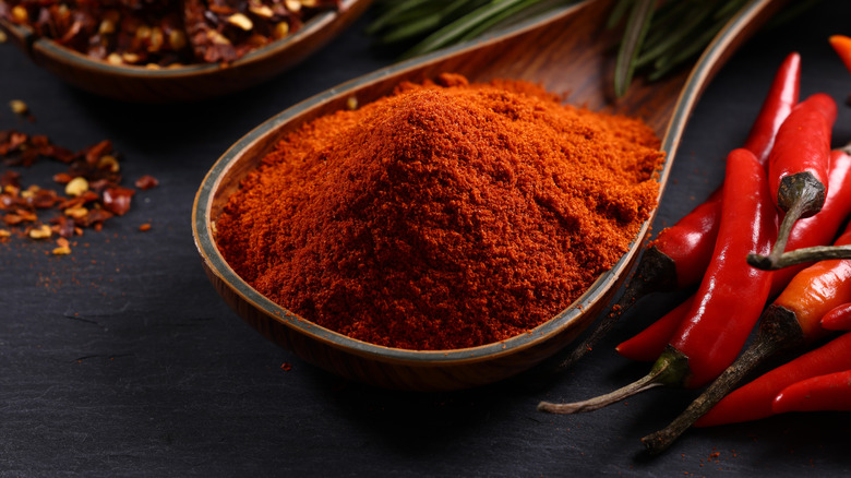 Paprika in spoon with peppers