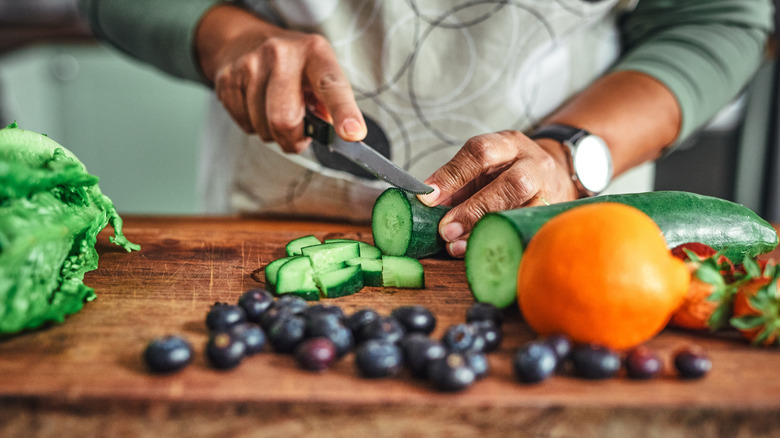 chopping cucumber with knife