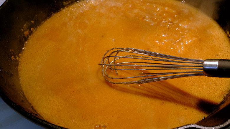 Stirring gravy with a whisk