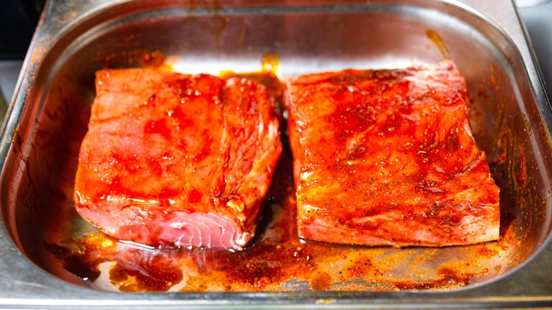 Two salmon fillets marinating.