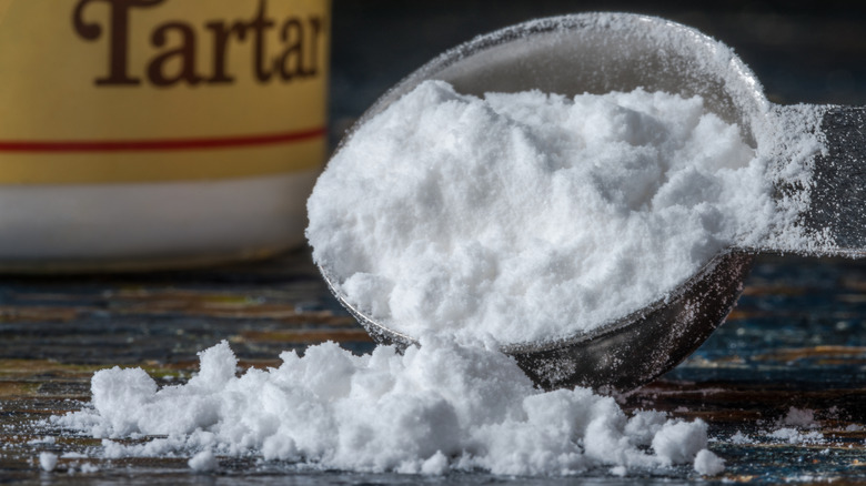 Cream of tartar spilling from measuring spoon
