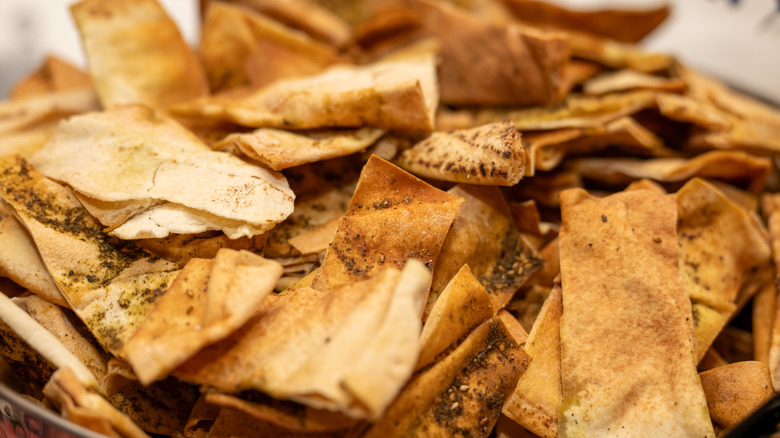Pita chips piled up in a bowl.