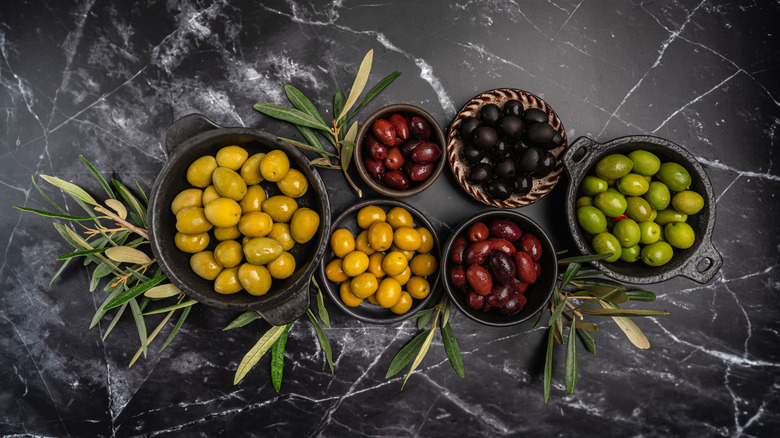 Olives in bowls on a marble table