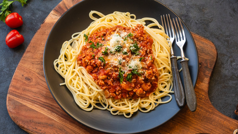spaghetti in a cast iron skillet with marinara sauce