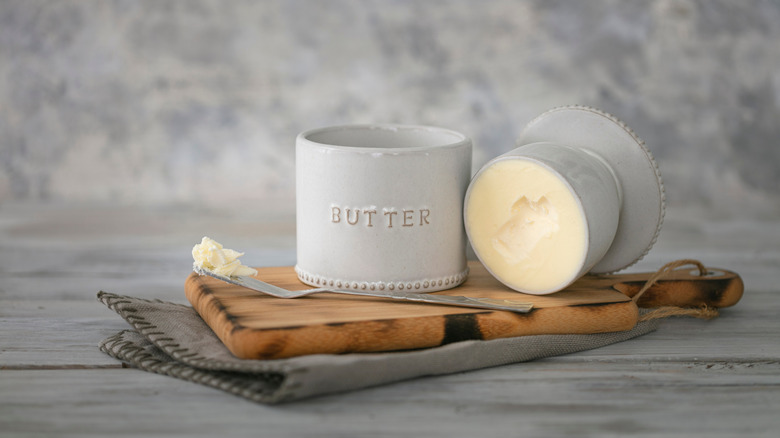 A white ceramic butter bell filled with butter