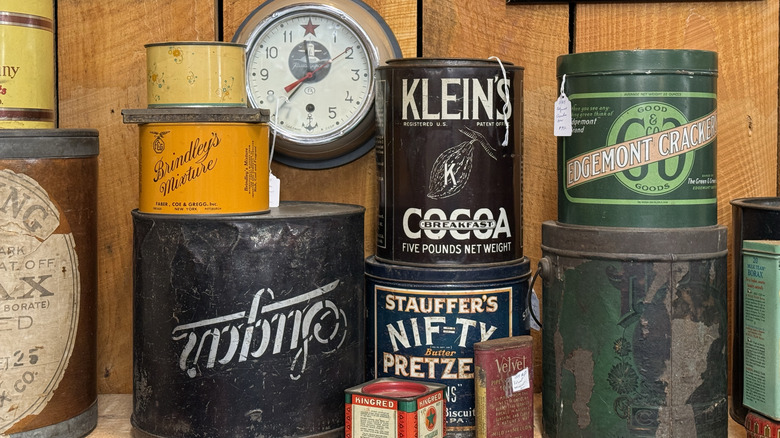 Vintage cans on a shelf at a shop.
