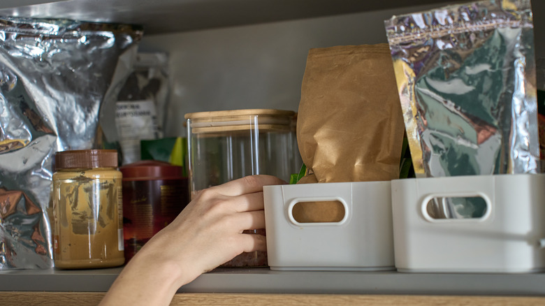 an organized pantry, including a few bins with items inside