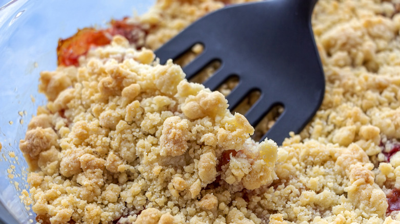 Spatula scooping up fruit crisp or cobbler