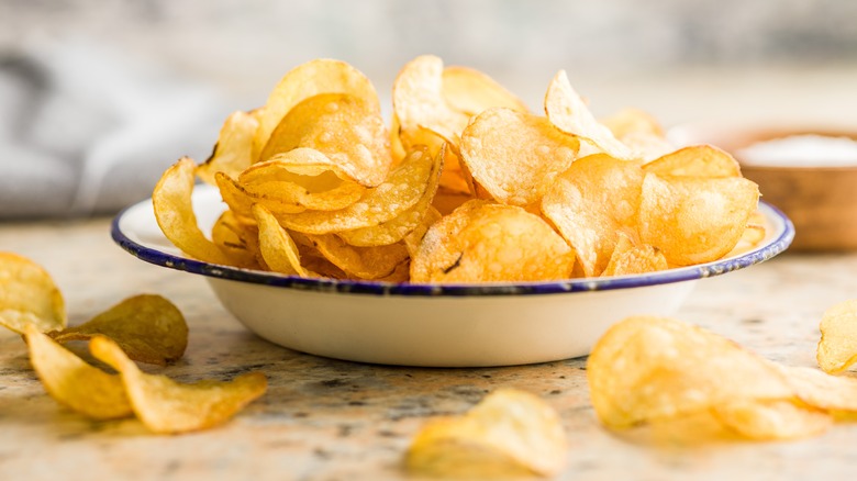 Homemade potato chips in a bowl on a counter