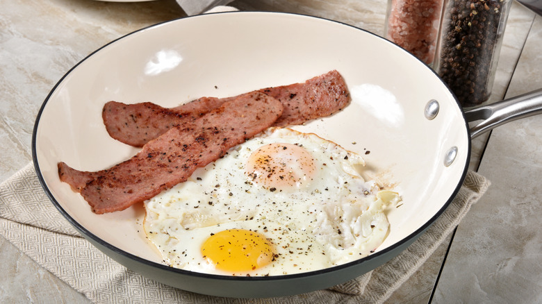 Turkey bacon in pan with eggs