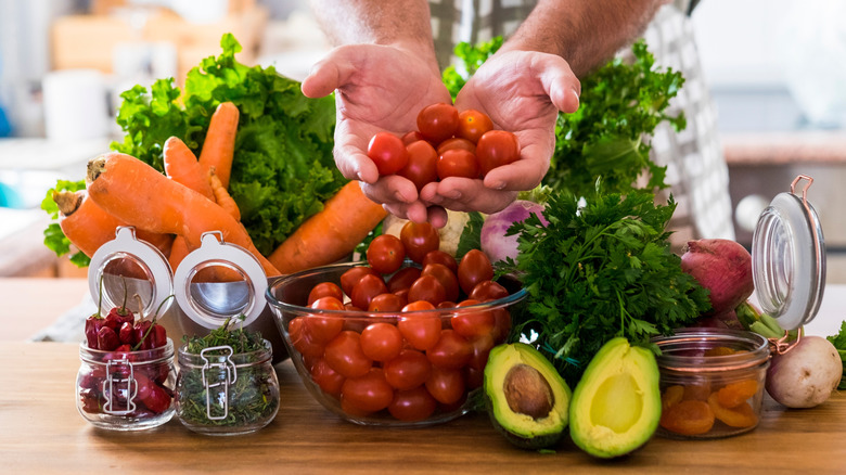 Fresh colorful fruits and vegetables displayed or being cut and prepared, symbol of healthy eating, organic nutrition, natural food