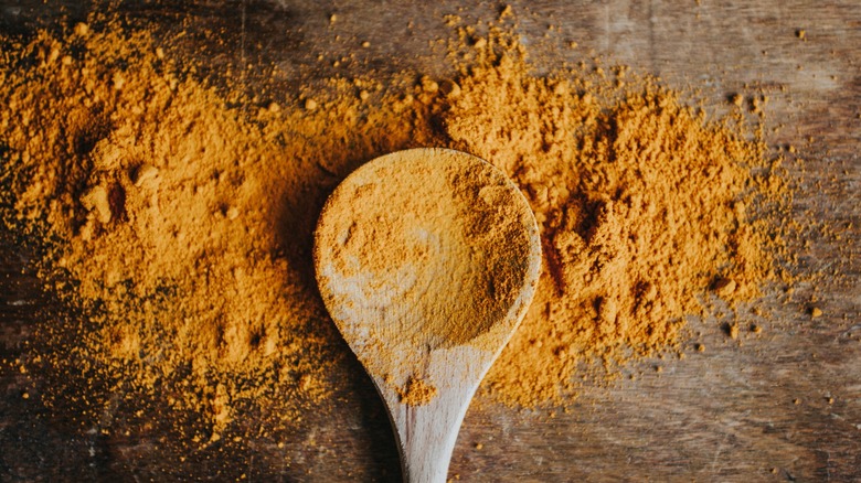 Turmeric on wooden spoon