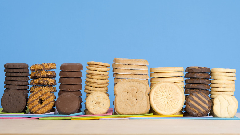 Stacks of Girl Scout cookies on a blue background
