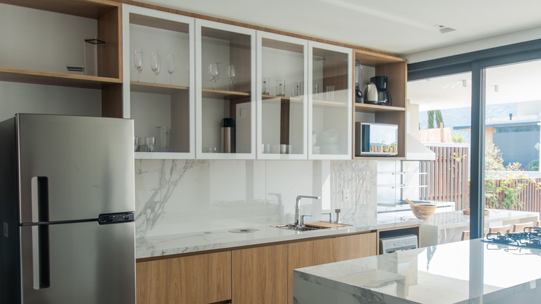 glass-fronted minimal cabinets in kitchen