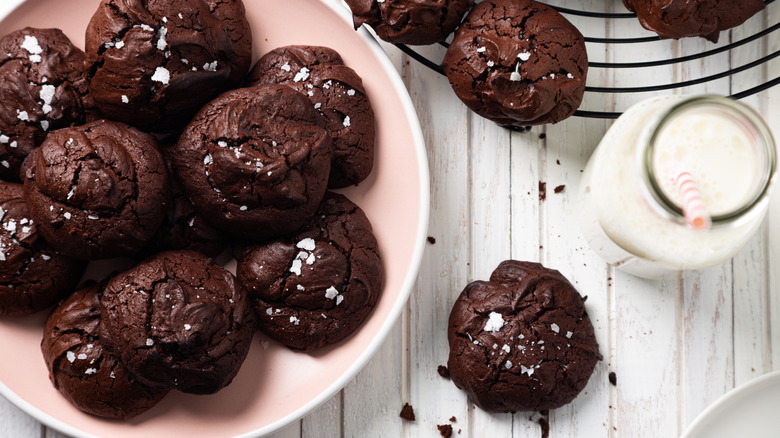 chocolate brownie cookies on a plate with milk