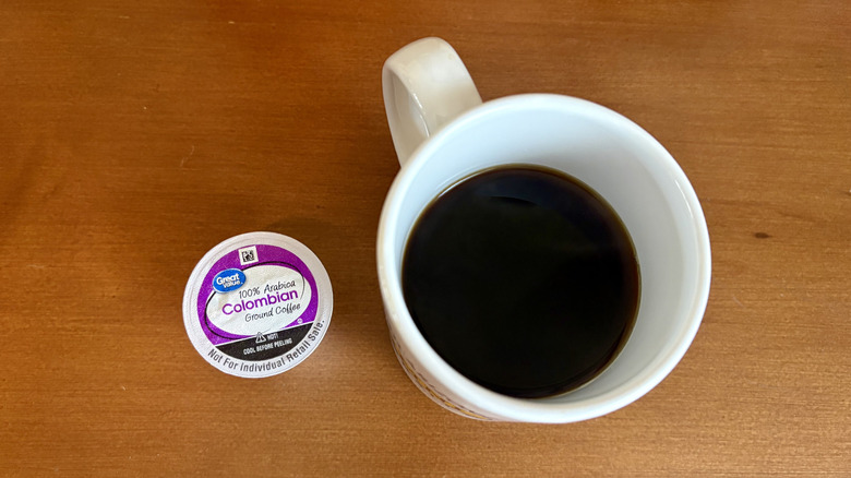 A mug of Great Value Columbian Roast coffee next to a pod