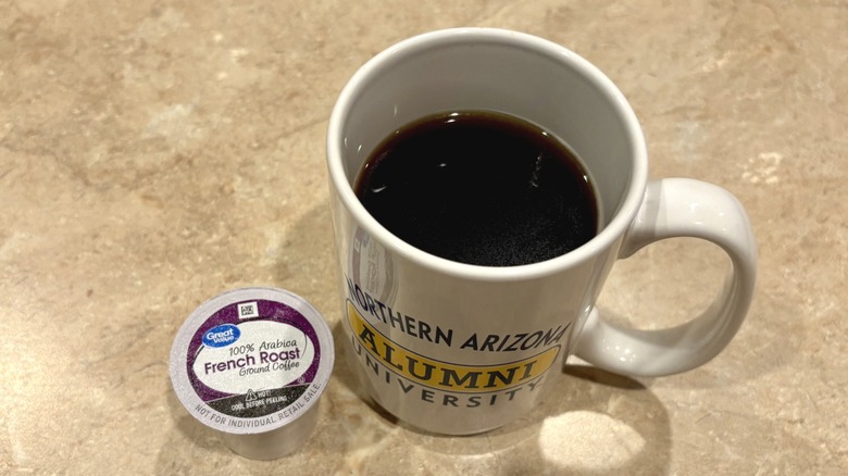 A mug of Great Value French Roast coffee next to a pod