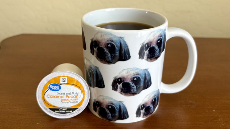 A mug of Great Value Caramel Pecan coffee next to a pod