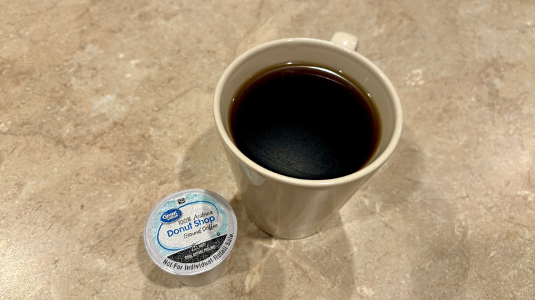 A mug of Great Value Donut Shop coffee next to a pod
