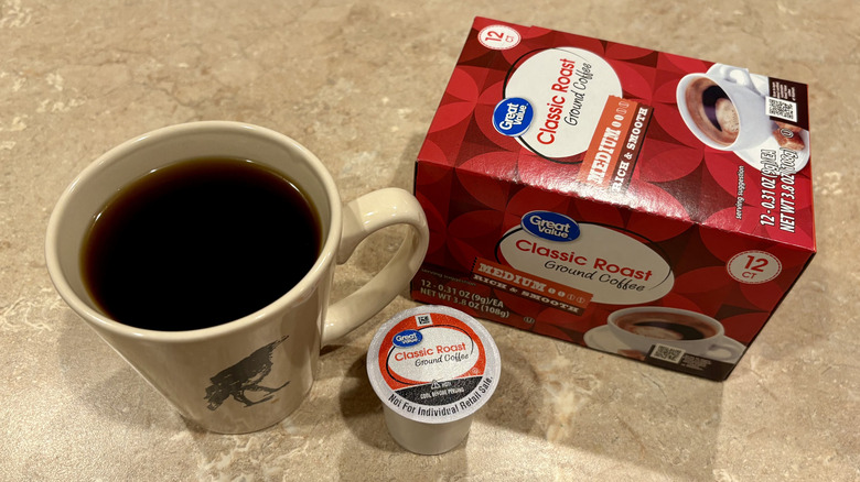 A mug of Great Value Classic Roast coffee next to its box and a pod