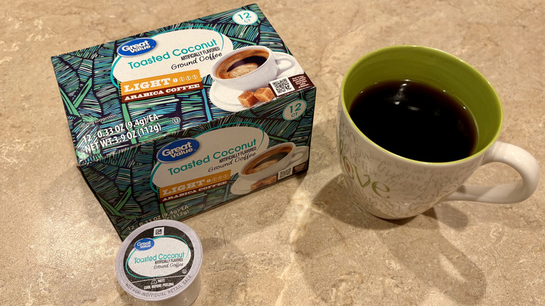 A mug of Great Value Toasted Coconut coffee next to a pod and its box