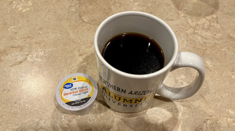 A mug of Great Value Breakfast Blend coffee next to a pod
