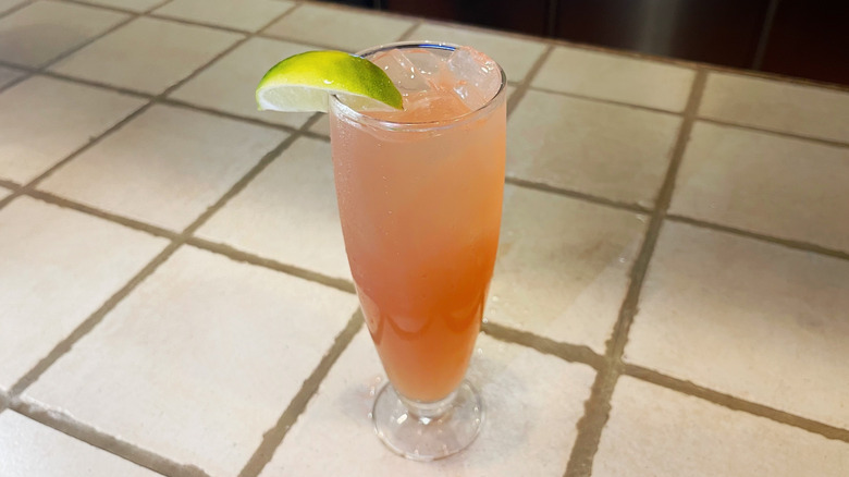 The Italian Rum Punch from Olive Garden on a white bar top with a lime garnish