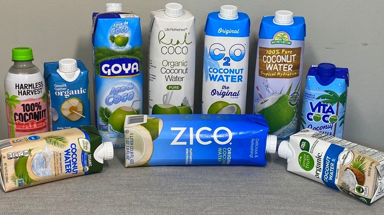 10 bottles of coconut water arranged on a table