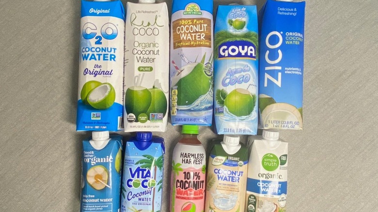 10 coconut water brands arranged flat on a table in two rows