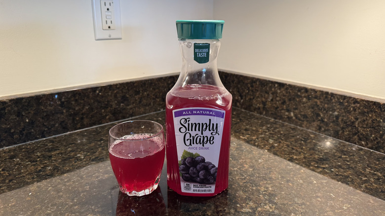 Grape juice with glass on a countertop