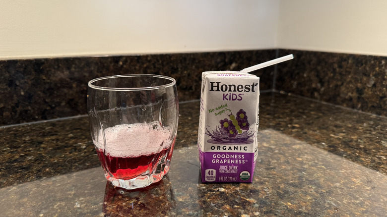 Grape juice with glass on a countertop