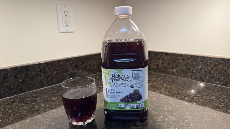 Grape juice with glass on a countertop