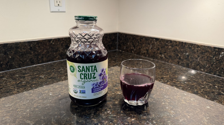 Grape juice with glass on a countertop