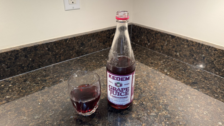 Grape juice with glass on a countertop
