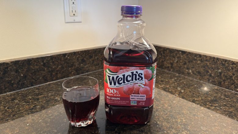 Grape juice with glass on a countertop