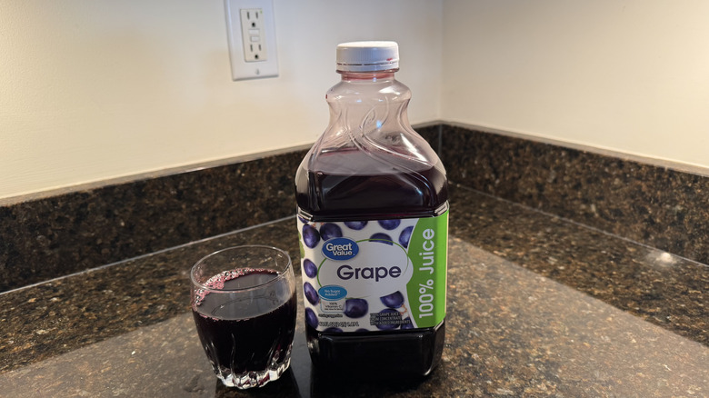 Grape juice with glass on a countertop