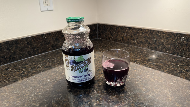 Grape juice with glass on a countertop