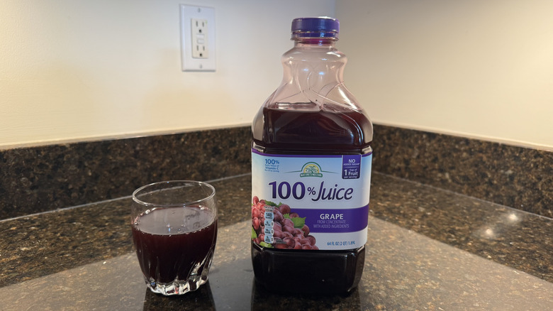 Grape juice with glass on a countertop