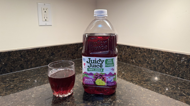 Grape juice with glass on a countertop