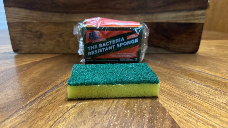 A package of Brillo sponges on a wooden background