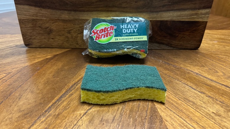 A package of Scotch-Brite sponges with a wooden background