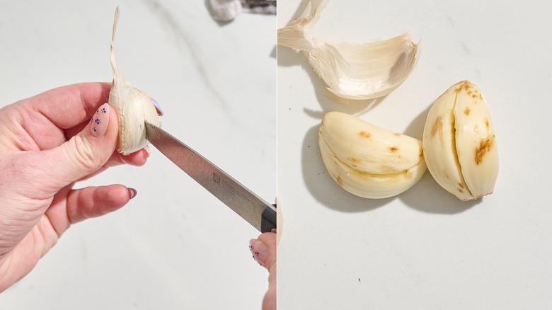 piercing a garlic clove with a knife next to the resulting peeled garlic